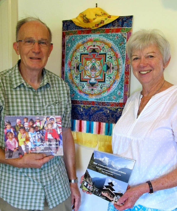 Northern Rivers residents John and Helen Niven with calendars of Nepal that they produce to support their volunteer dental work in the Himalayan country.