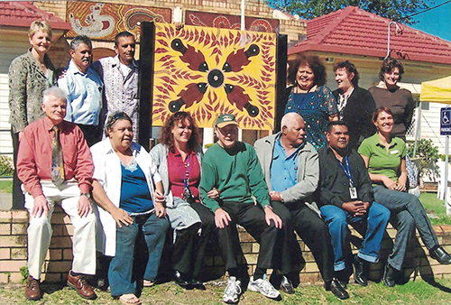 Staff and supporters of Jullums Lismore’s AMS (Note: photo does contain pictures of Aboriginal people who have died)